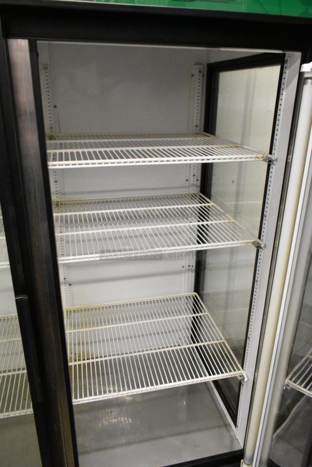 True GEM-49 metal commercial cooler with two glass doors, poly-coated racks, 115 volts, 1 phase, excellent condition.