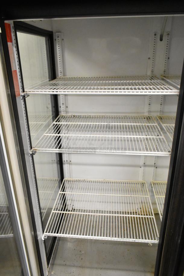 True GEM-49 commercial cooler, metal, 2-door, four poly-coated racks, 115V, 1 Phase, interior view, fair condition.