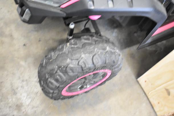 2022 Pinghu 2000W children's electric car wheel, features rugged tire tread and pink rim accent, in good condition.