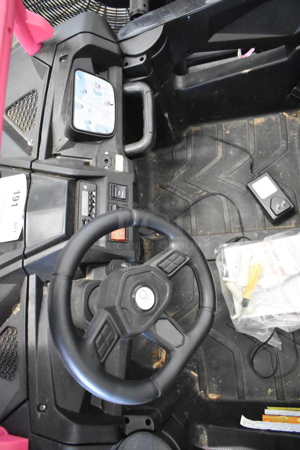 2022 Pinghu 2000W Electric Children's Car interior, featuring a black steering wheel, dashboard controls, and floor mat.