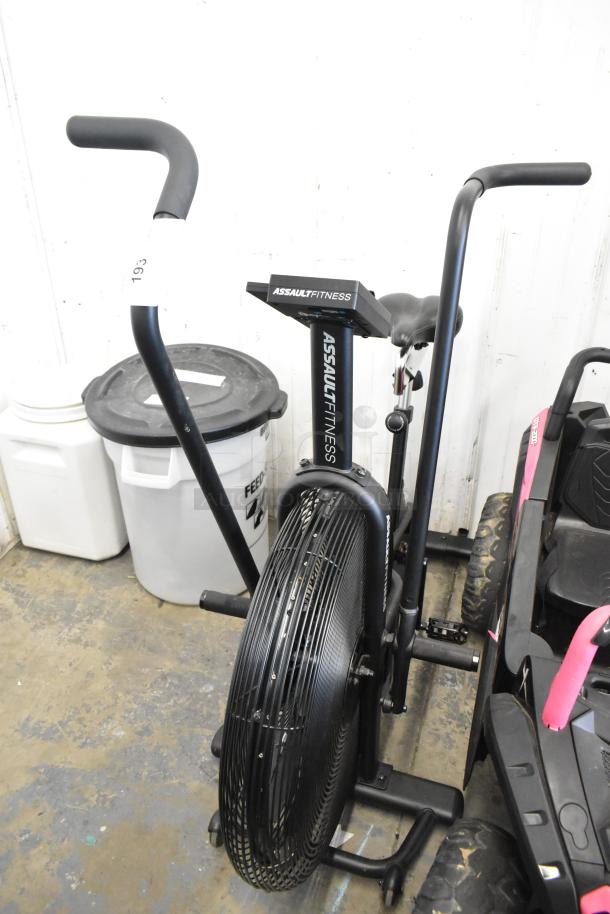 Assault Fitness Stationary Exercise Bicycle, sturdy frame, dual-action handlebars, fan resistance, good condition.
