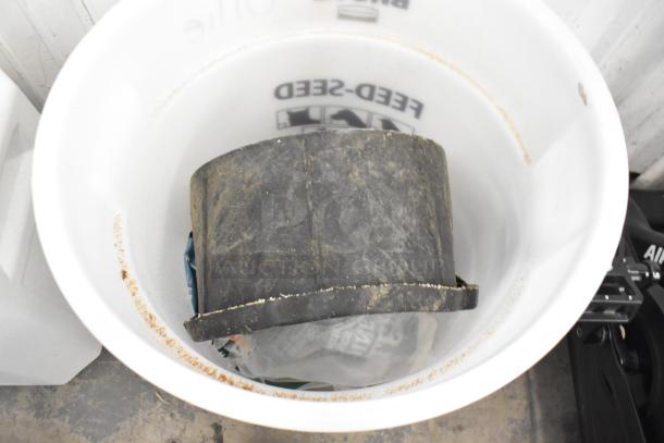 White poly bin with black inner container, used condition, visible feed seed label inside.