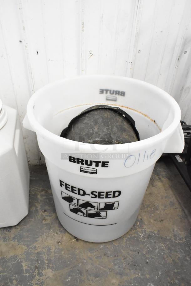 White Rubbermaid Brute poly bin labeled "Feed-Seed," slightly used, with handle. "Ollie" written on side. Auction: 2x your bid.