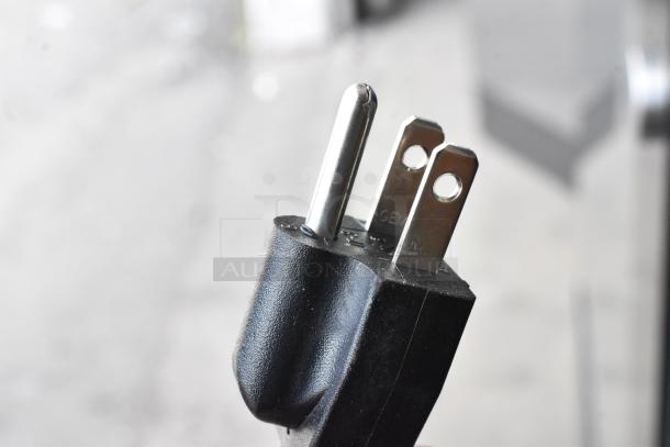 Close-up of the electrical plug for an Avantco 193BCD48B bakery display case. Plug features two flat prongs and one round prong.