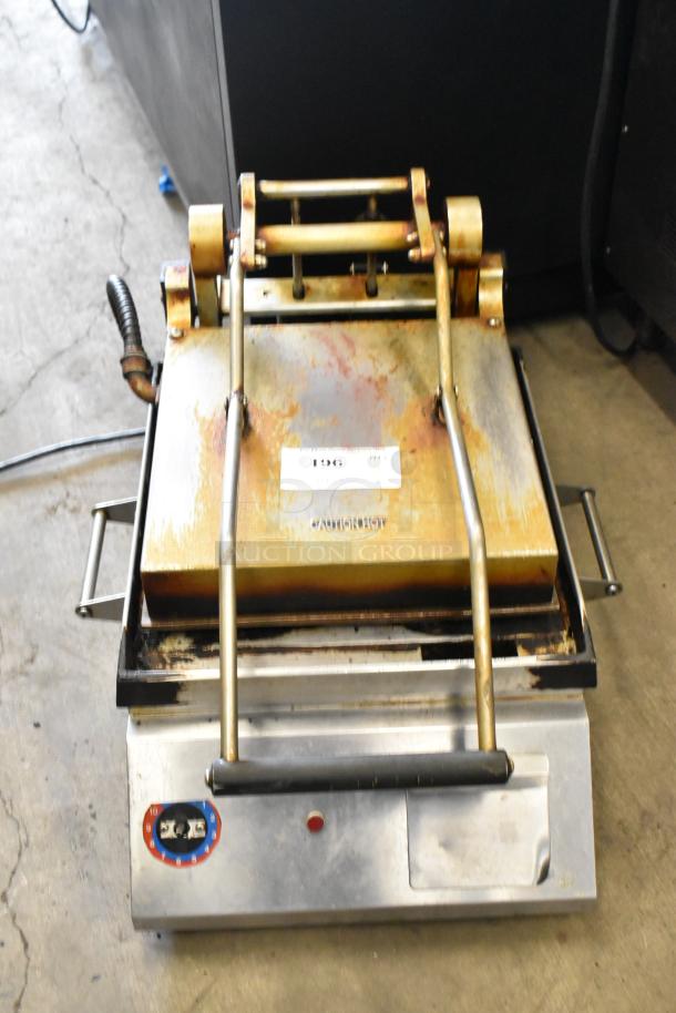 Metal commercial countertop panini press, 115 volts, 1 phase. Features a metal handle and temperature dial. Used condition.
