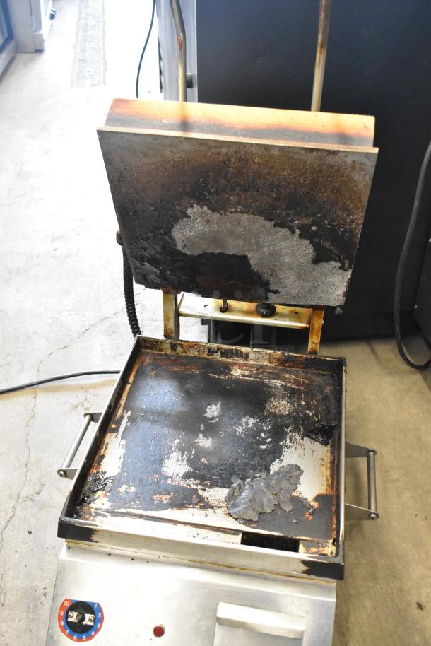 Metal commercial countertop panini press merchandiser, 115 volts, 1 phase, visible wear and rust, dual temperature knobs.