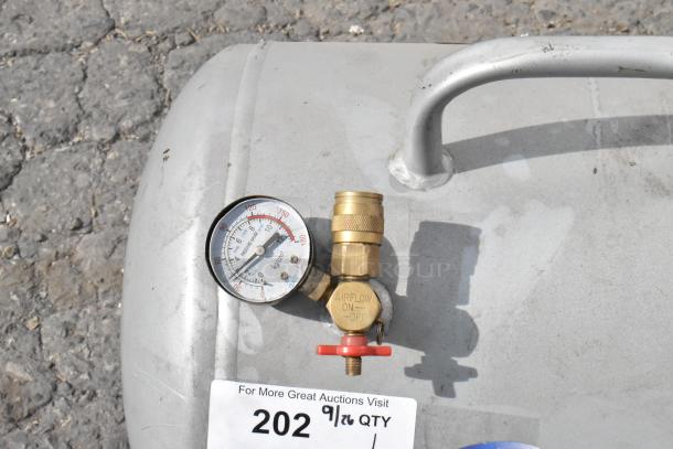California Air Tools tank with pressure gauge and brass valve, showing airflow settings. Slight wear visible on surface.