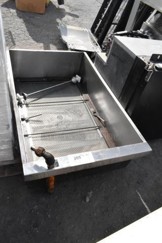 Stainless steel commercial grease trap, visible mesh filter, minor rust on outlet, condition used, tag reads "205."