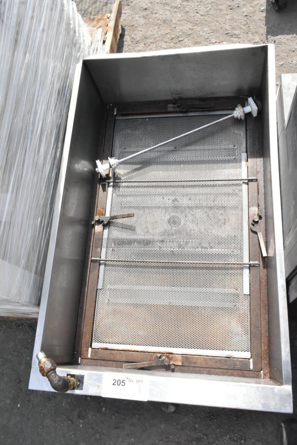 Stainless steel commercial grease trap with internal mesh strainers. Shows signs of use. Tag indicates quantity 1, number 205.