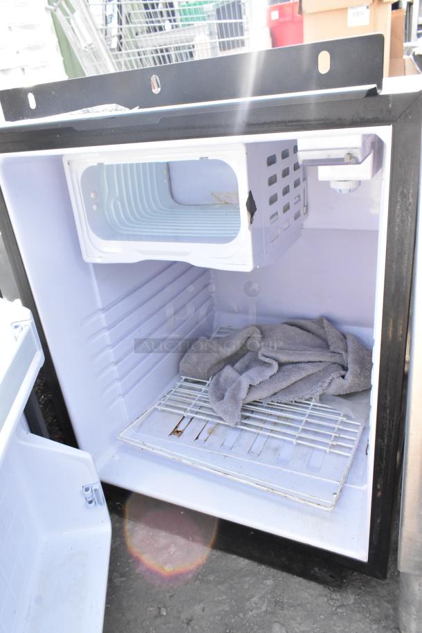 WW17128-4a Mini Cooler, 115 Volts, 1 Phase. Interior view with shelves, used condition, gray towel inside.