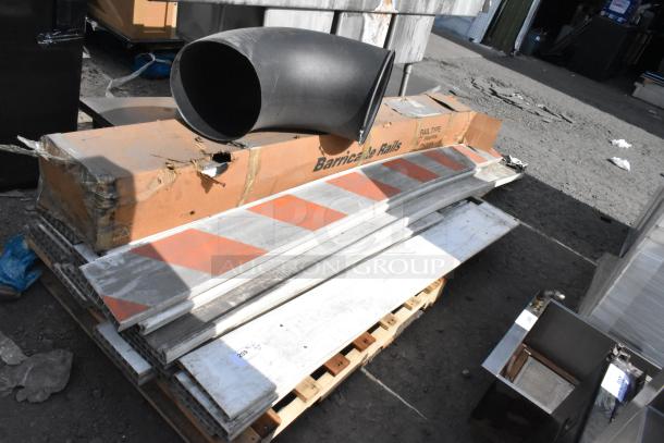 Pallet lot including barricade rails in used condition, with visible orange and white stripes on metal rails. Boxes labeled "Barricade Rails."