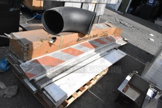 Pallet lot including barricade rails in used condition, with visible orange and white stripes on metal rails. Boxes labeled "Barricade Rails."