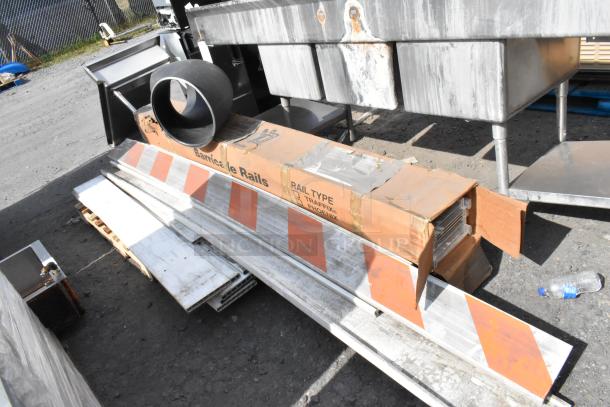 Pallet lot containing barricade rails and various metal items in used condition. Box labeled "Barricade Rails, Rail Type: TRAFFIX, PHOENIX."