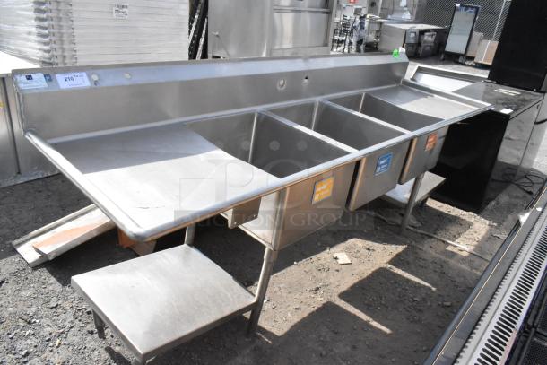 Stainless steel 3 bay sink with dual drain boards, excellent condition, labeled bays for washing, durable and spacious.