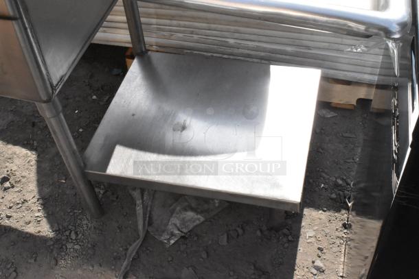 Stainless steel 3 bay sink with dual drain boards. Visible sturdy legs and lower shelf, suitable for commercial use.