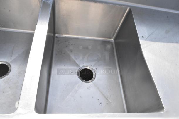 Stainless Steel 3 Bay Sink with dual drain boards, showing two of the basins, in good condition with minor surface marks.