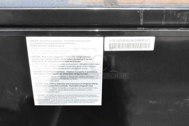 "Frigidaire chest freezer warning label showing safety instructions and serial number."