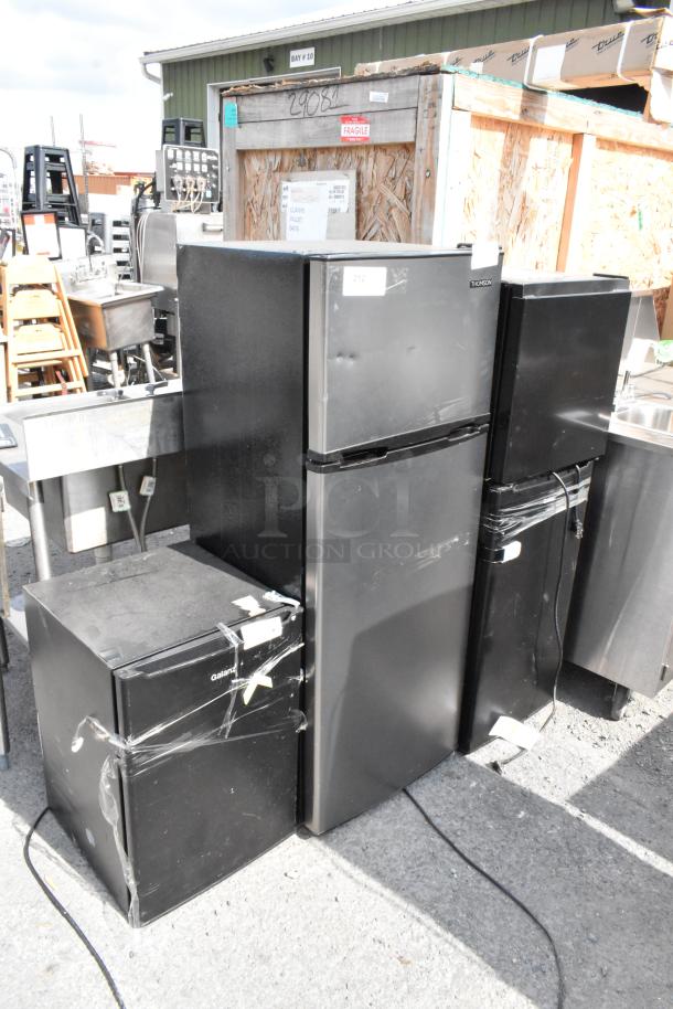 Four black mini coolers including Galanz GLR25MBKE02, Thomson TFR725, Hisense WMS017M6XBE, and Galanz GLR33MBKE23. 115V, 1 Phase.