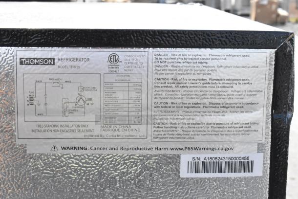 Thomson TFR725 refrigerator label showing model specs, safety warnings for refrigerant, and serial number A1808243150000456.