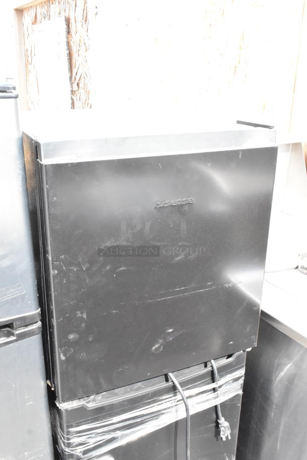 Hisense WMS017M6XBE mini cooler, black finish, visible power cord, some surface marks, runs on 115 volts, 1 phase.
