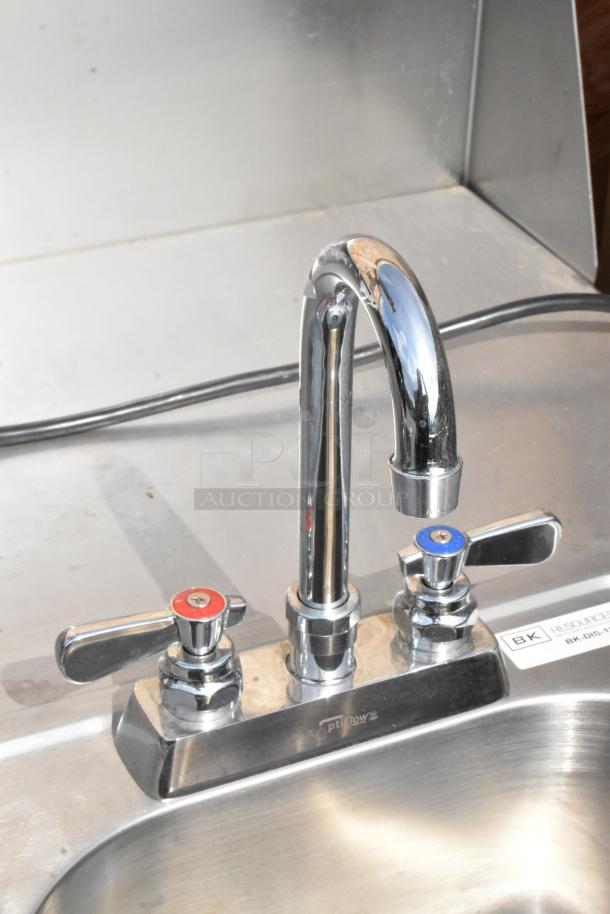 QualServ stainless steel portable sink with commercial casters, features dual-handle faucet, clean condition, visible brand marking.