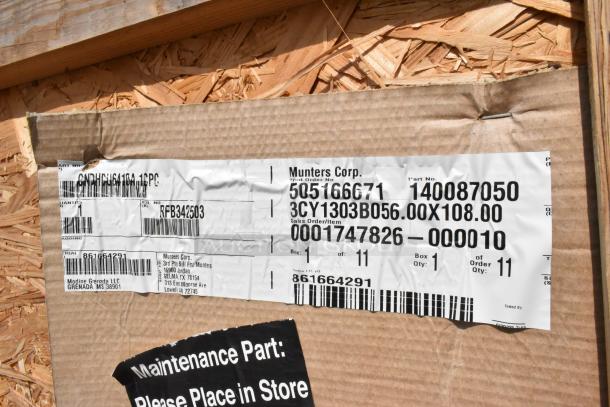Brand new Munters Corp evaporator coil in crate with product labels showing part numbers and shipping details.