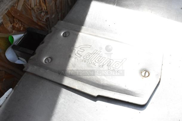 Stainless Steel Single Bay Sink with under shelf, Edlund branding, screws visible, light scratches, industrial use.