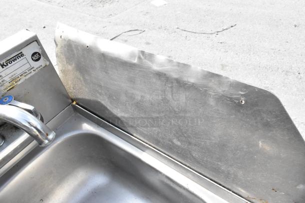Stainless steel single bay sink with side splash guard, features Krowne label, NSF certified, in used condition.
