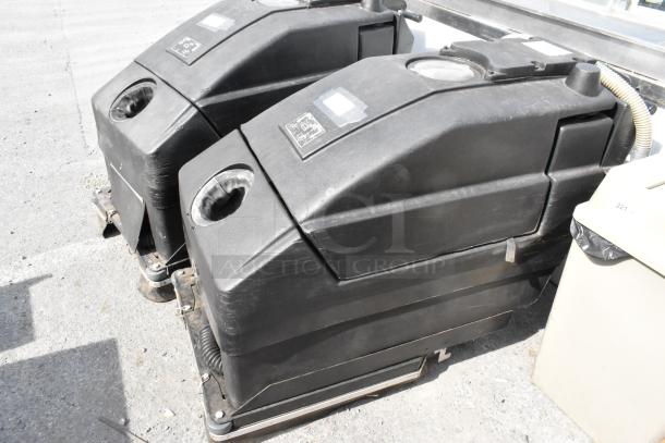 NSS Wrangler 2625 DB floor scrubber; black, large industrial cleaning machine; showing signs of wear; no visible labels.
