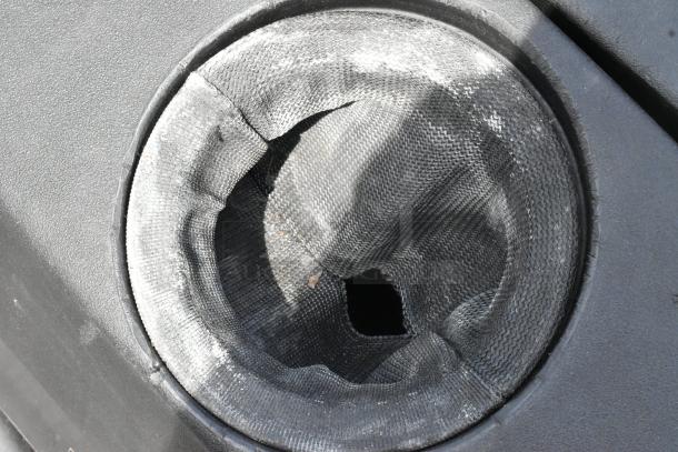 Close-up of NSS Wrangler 2625 DB Floor Scrubber, showing the worn fabric filter in used condition.
