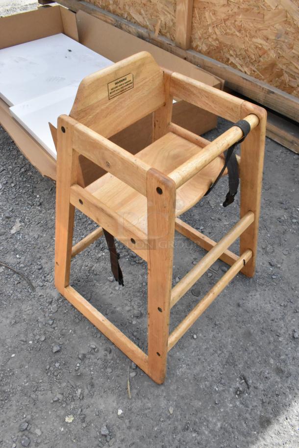 Three sturdy wooden high chairs with harnesses and warning label, lightly used condition, suitable for toddlers.