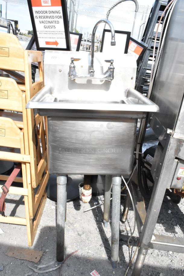 Stainless steel single bay sink with high faucet and dual handles. Appears in good condition, ideal for commercial use.