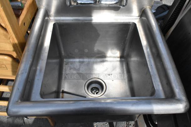 Stainless Steel Single Bay Sink in used condition, with minor scratches and a visible drain hole, shown in an outdoor setting.