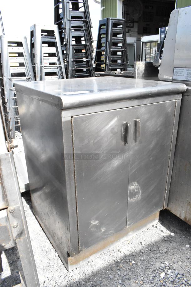 Stainless steel table with 2 doors and 2 under shelves, showing light wear. Polished surface and sturdy construction.