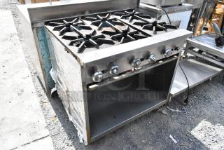 Stainless steel commercial 6 burner gas range with under shelf, showing signs of use, ideal for professional kitchens.