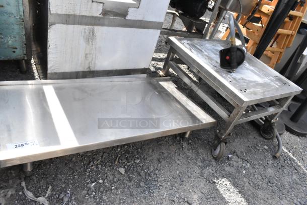 Two stainless steel items: a durable equipment stand with wheels and a flat shelf. Good condition, ideal for commercial use.