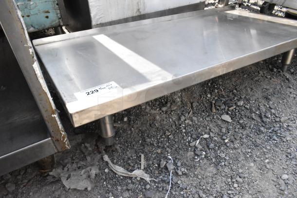 Stainless steel equipment stand with bottom shelf, used condition, visible tag marked "229" indicating auction lot.
