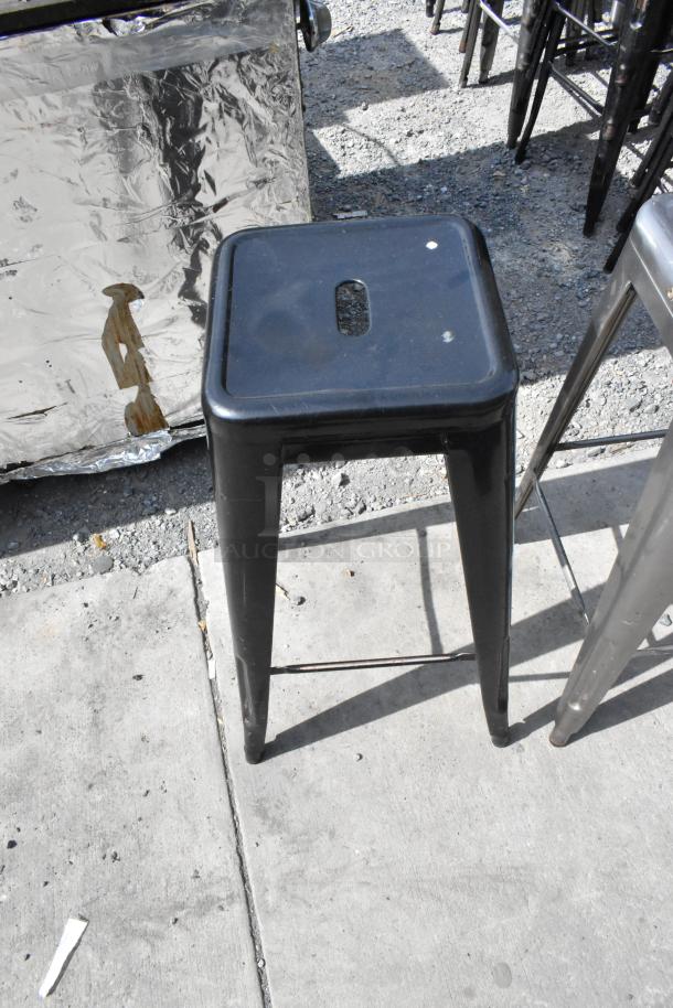 Black metal Tolix-style stool, stackable, showing minor wear. Auction for 40 units.