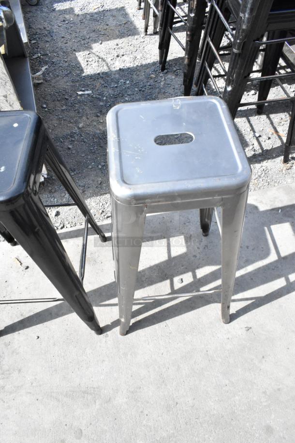 Metal Tolix style stool, industrial design, stackable, worn condition, silver finish. Set of 40 available for auction.