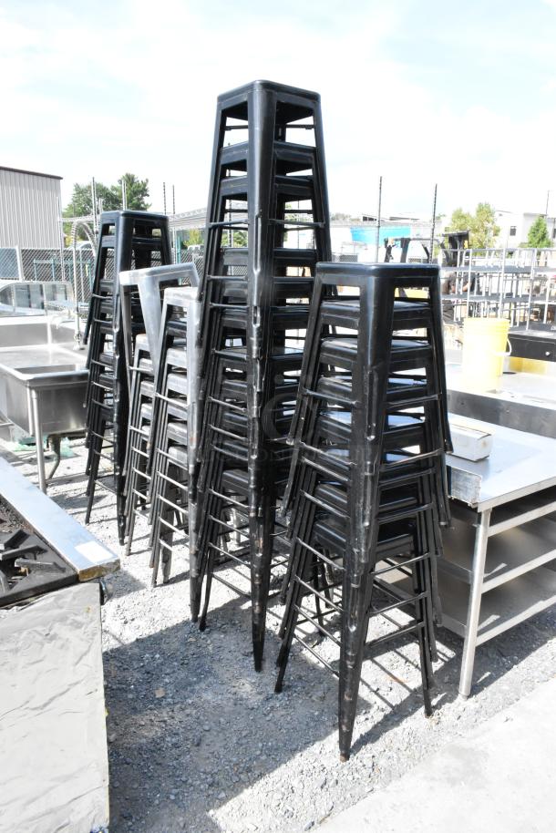 40 stackable black Tolix style metal stools in used condition. Ideal for commercial or industrial settings.