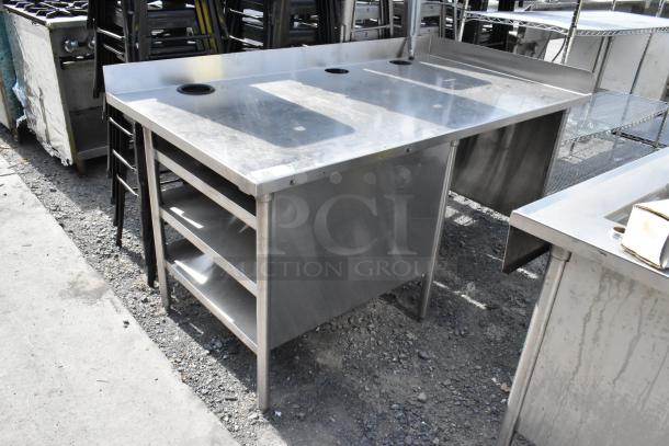 Stainless steel table with three under shelves, side splash guards, and circular cutouts on top. Industrial-grade and durable.