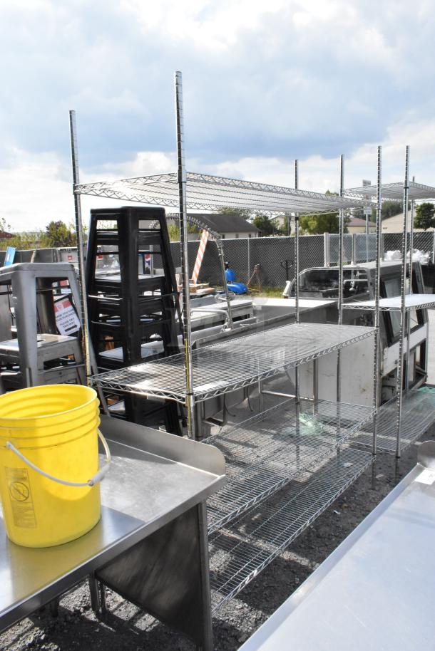 Chrome finish 4-tier wire shelving unit in good condition. Buyer must dismantle. Consider freight charges for shipping.