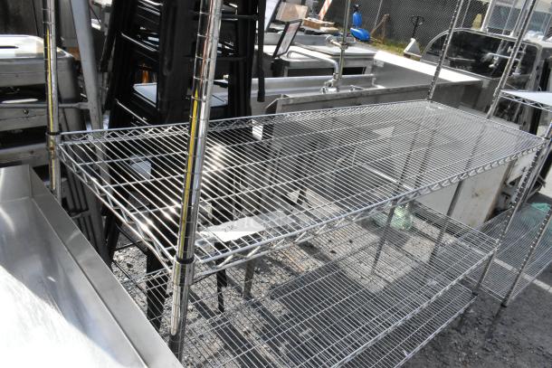 Chrome finish 4-tier wire shelving unit, in good condition. Note: Buyer must dismantle; freight charges apply.