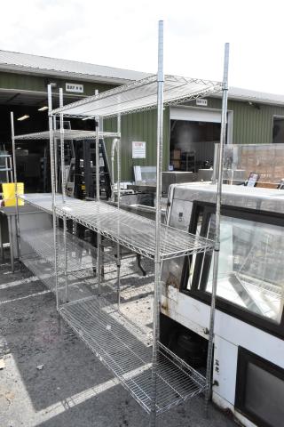 Chrome finish 3 tier wire shelving unit in outdoor setting. Buyer must dismantle. Consider freight charges.