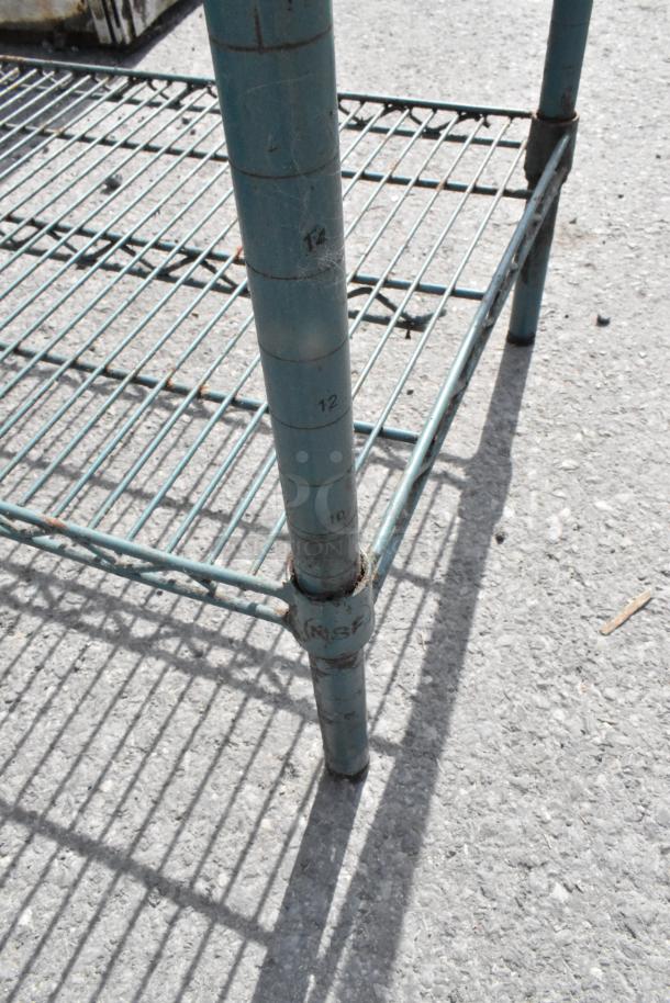 Green 4-tier wire shelving unit, showing wear and rust. Includes numbered support posts. Buyer dismantling required.