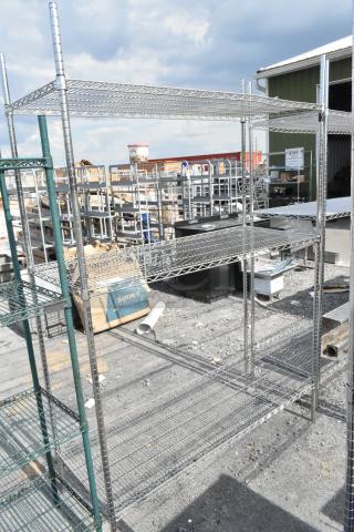 Chrome finish 4 tier wire shelving unit, in good condition, requires buyer dismantling; freight charges apply.