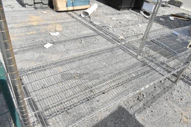 Chrome finish 4-tier wire shelving unit outdoors, showing sturdy metal construction. Buyer must dismantle; consider freight.