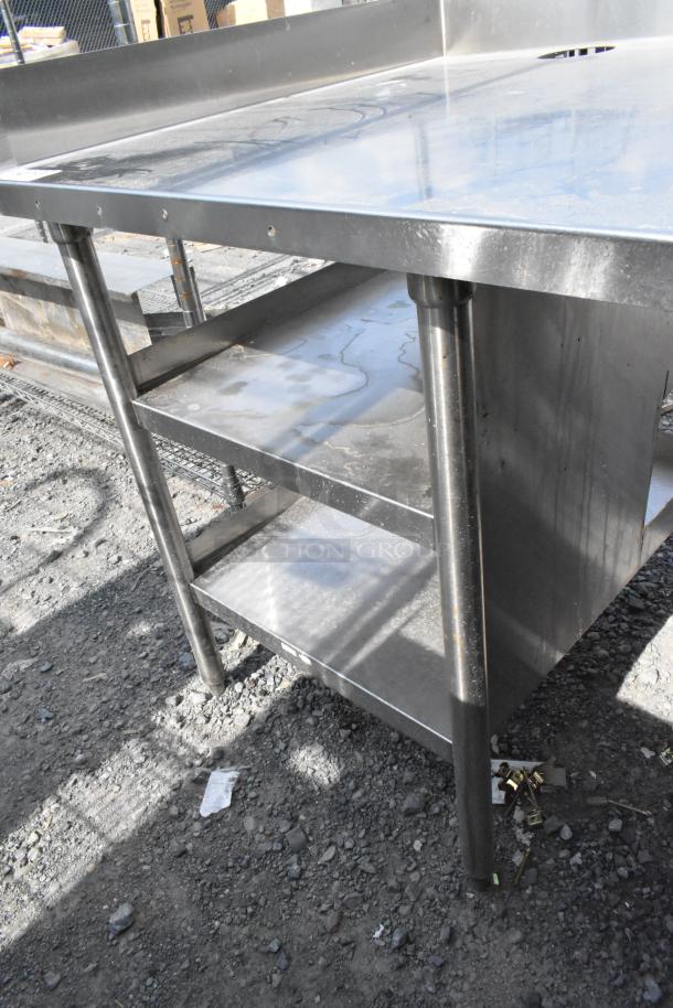 Stainless steel soda station with under shelves, durable construction, visible wear, suitable for commercial use.