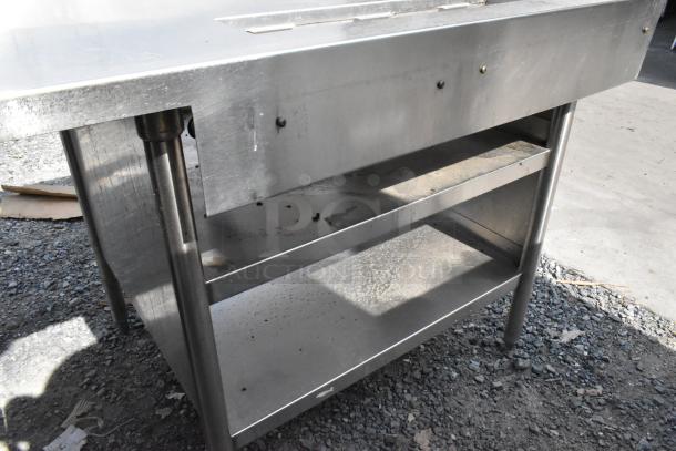 Stainless steel soda station with two under shelves; durable, industrial use, with minor surface wear, ideal for restaurants.