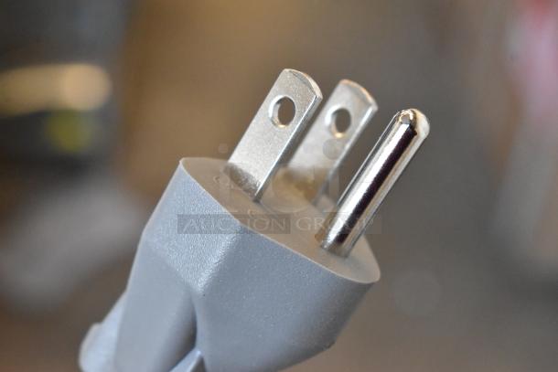 Close-up of a gray electrical plug for a KoolMore KM-MOT-1SS microwave, showing three metal prongs.